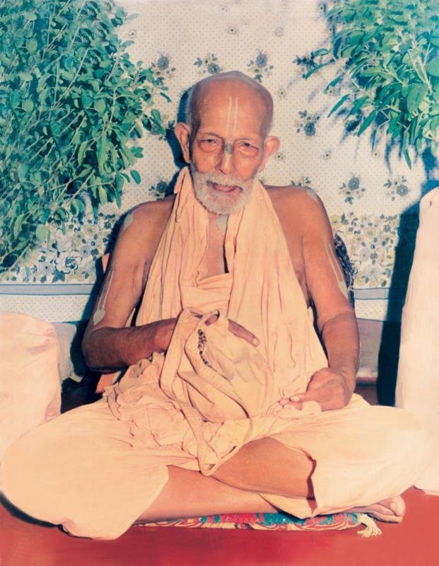 Srila Bhakti Promode Puri Goswami Maharaja, seated in saffron cloth with tilaka, in his later years