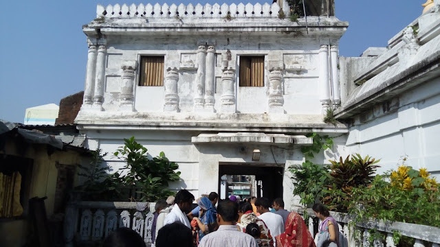 Exterior view of the Radha Kanta Matha (the Gambhira) in Puri, with pilgrims entering - the temple Gopala Guru Goswami served and expanded, still an active pilgrimage site today.