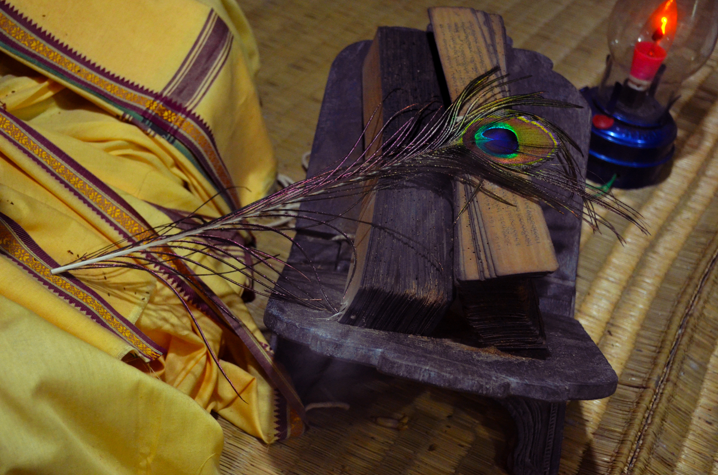 An original palm-leaf manuscript of the Gita Govinda, with a peacock feather used as a page-marker, preserved at the Odisha State Museum, Bhubaneswar.