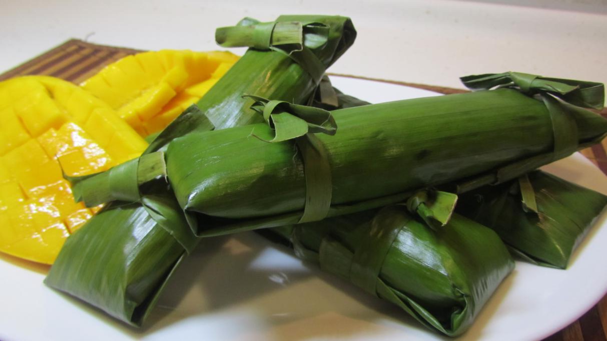 A photograph of sliced mangoes beside leaf-wrapped prasada parcels, used on gaudiyahistory.iskcondesiretree.com's biography page for Kali Das — chosen for this page because it directly evokes the episode of Kali Das bringing ripe mangoes as