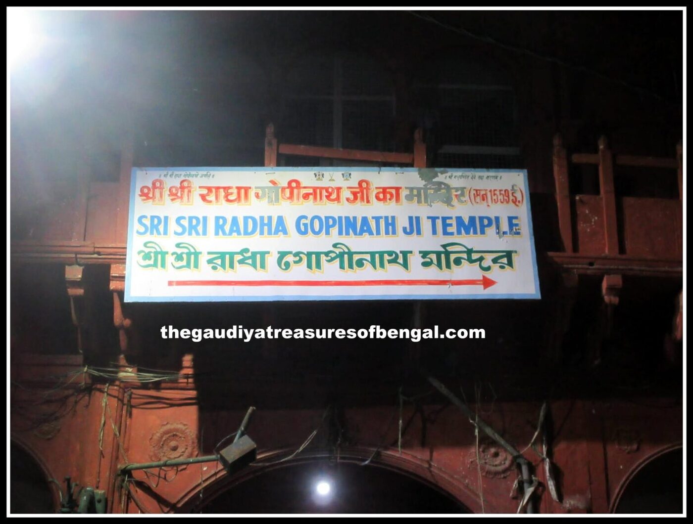 The signboard at the entrance to the Sri Sri Radha Gopinath Ji Temple in Vrindavana, marking the site at Vamshivata where Madhu Pandit Goswami served the Deity.