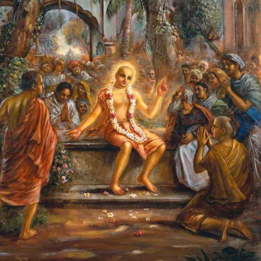 A traditional Gaudiya Vaishnava devotional painting of Sri Chaitanya Mahaprabhu, surrounded by a crowd of devotees, with a brahmana bowing at His feet — evoking His stay at the house of Vidya-Vacaspati (Madhusudana Vachaspati) at Vidyanagar
