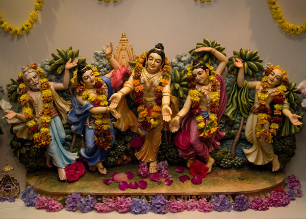 A Panca-tattva altar showing the five deities — Sri Chaitanya Mahaprabhu, Nityananda Prabhu, Advaita Acharya, Gadadhara Pandita and Srivasa Thakura — standing together with raised arms.