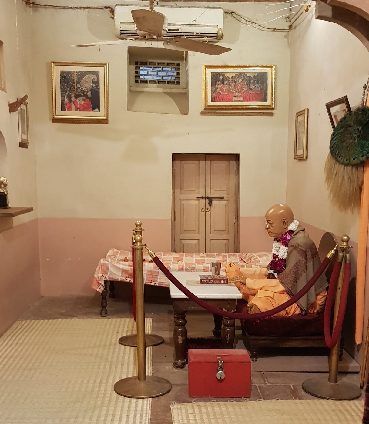 The preserved ground-floor room at Radha-Damodar Mandir, Vrindavan, where Srila Prabhupada lived and wrote from 1962 to 1965; now kept as a memorial, with a statue of him seated at his old writing table.