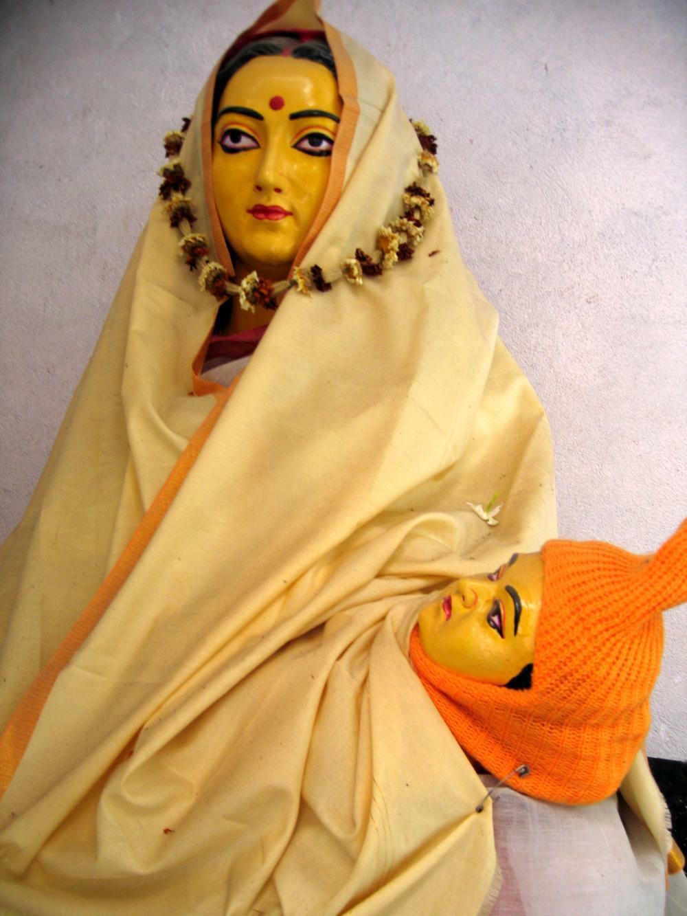 The Deity of baby Raghunandana Thakura on the lap of his mother, worshiped at his birthplace of Srikhanda.
