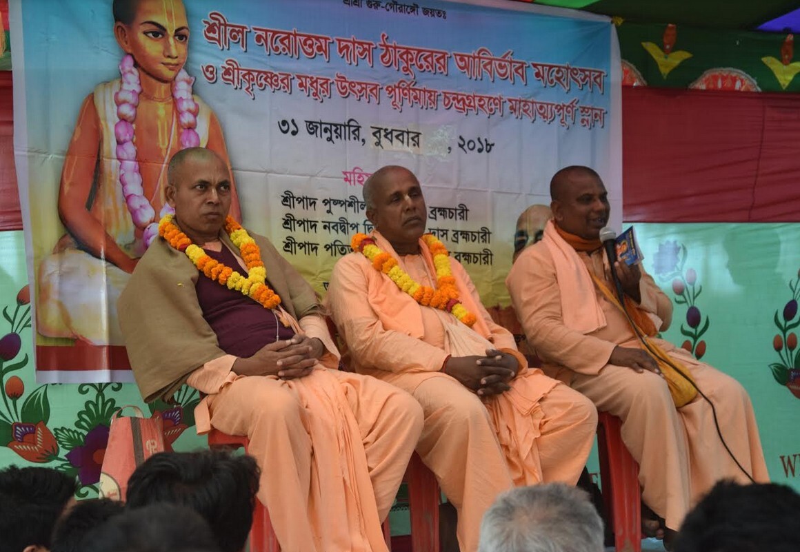 ISKCON Bangladesh sannyasis on stage beneath a portrait of Narottama Dasa Thakura at the 31 January 2018 Narottama Purnima festival held at Kheturi Dham, the temple site Santosha Datta built.