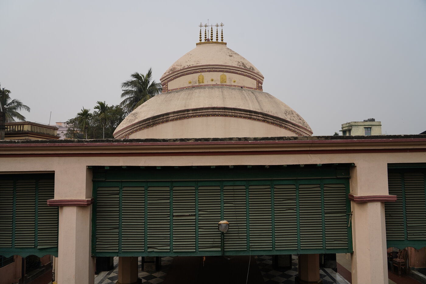 The Natmandir and temple grounds at Khardaha's Radha-Shyamsundar Jiu temple, the gathering place tradition associates with Viracandra Prabhu's own congregational sankirtana.