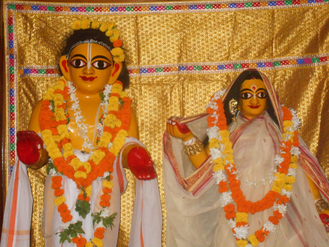 The deities of Advaita Acharya and Sita Thakurani, carved in wood, at the Sitanath Advaita Mandir, Nabadwip.